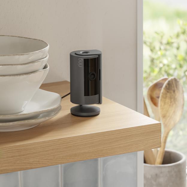 Ring 360-degree security camera on a wooden shelf.