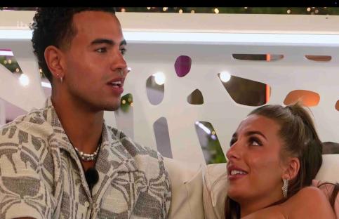 Toni and Harrison sharing a kiss on the terrace.