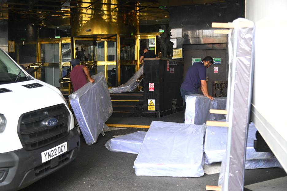 Mattresses being unloaded at a hotel.