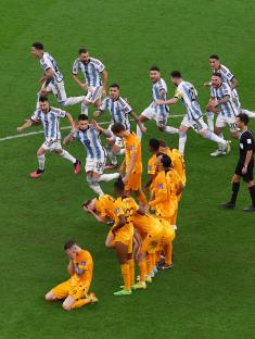 Argentina and Netherlands soccer players react after a penalty shootout.