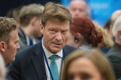 Close-up of a man in a suit speaking.