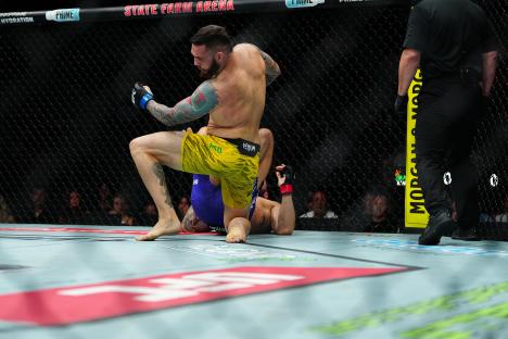 Paul Craig and Rodolfo Bellato fighting in a UFC match at State Farm Arena.