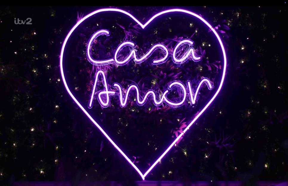 Purple neon heart sign that says