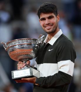 Carlos Alcaraz of Spain holding the Coupe des Mousquetaires trophy.