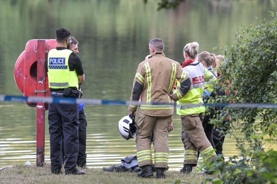 Emergency responders at a lake searching for a missing teenager.