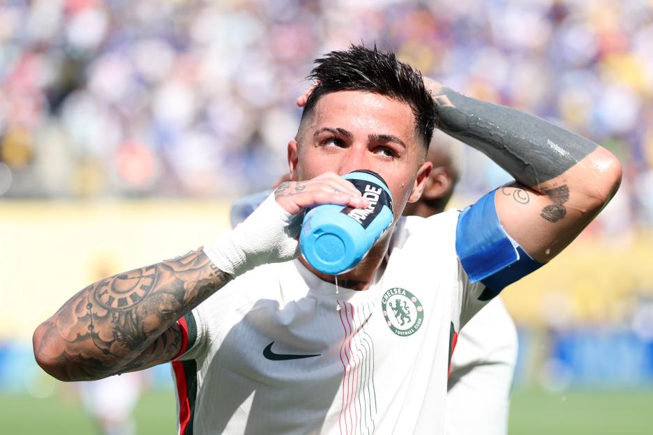 Enzo Fernandez of Chelsea FC drinking water during a hydration break.