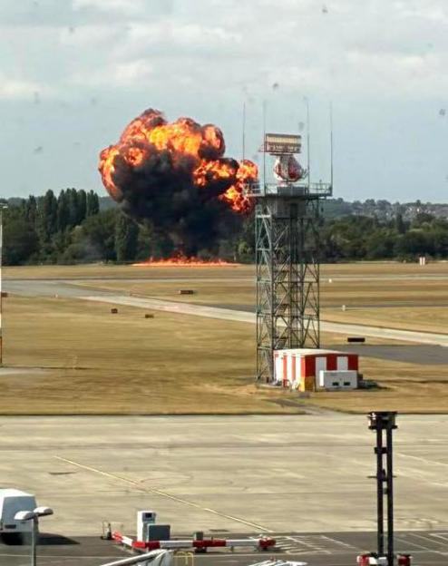 Small plane crash-landing in a large fireball at an airport.