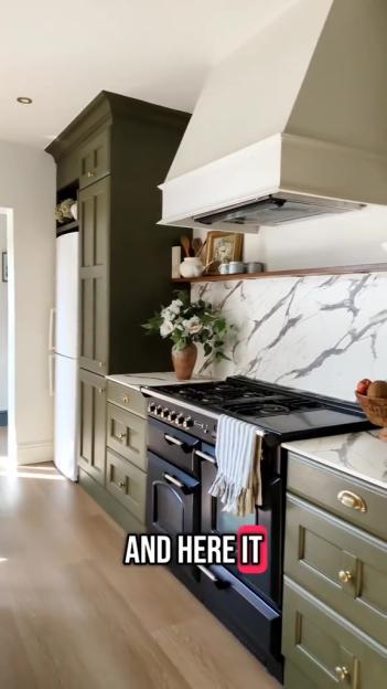 Renovated kitchen with olive green cabinets and marble backsplash.
