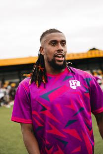 Alex Iwobi wearing a purple jersey with the number 12.