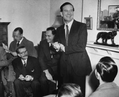 Kim Philby at a 1955 press conference, joking with reporters.