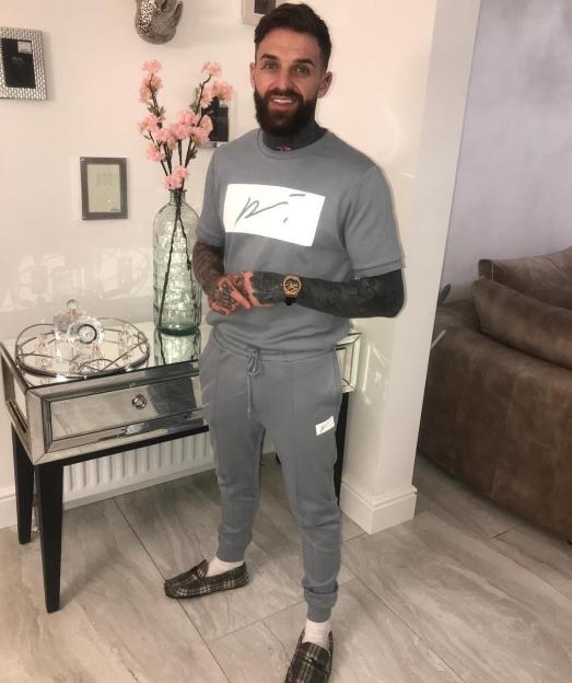 Man in gray sweatsuit.