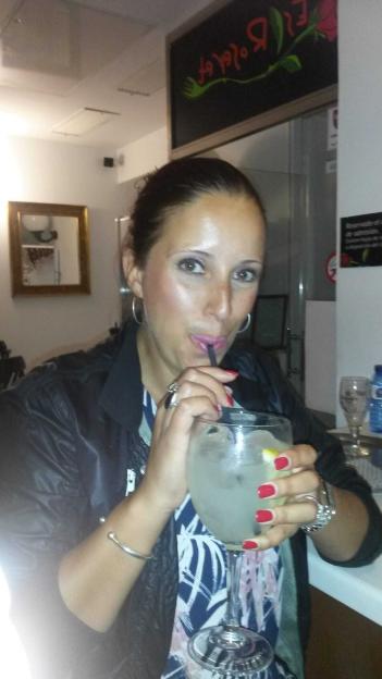 Woman drinking a gin and tonic.