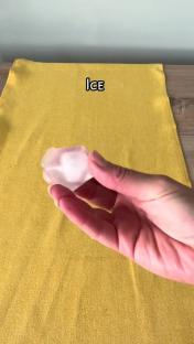 Hand holding an ice cube.
