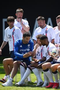 Soccer Aid for UNICEF 2025 training: players looking at a phone.