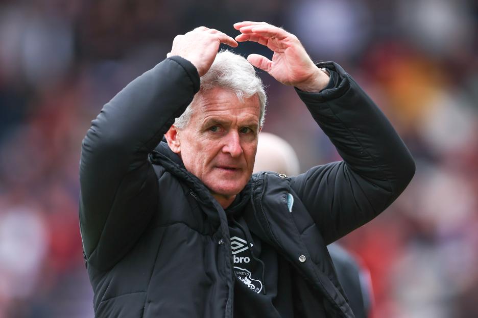 Mark Hughes, head coach of Carlisle United, reacting during a soccer match.