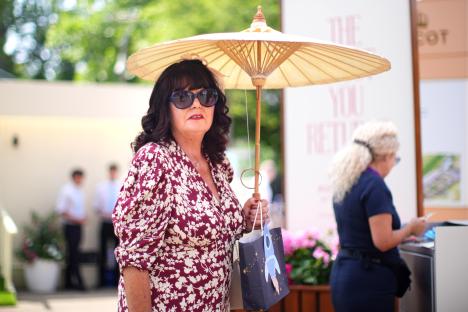 Woman at Royal Ascot holding parasol.