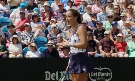 A tennis player speaks to the crowd.