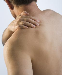 Man rubbing his sore shoulder.