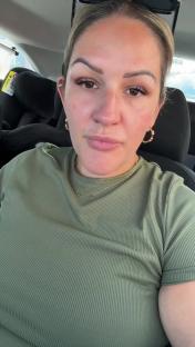 Woman in a car, talking about her son's cancelled party.