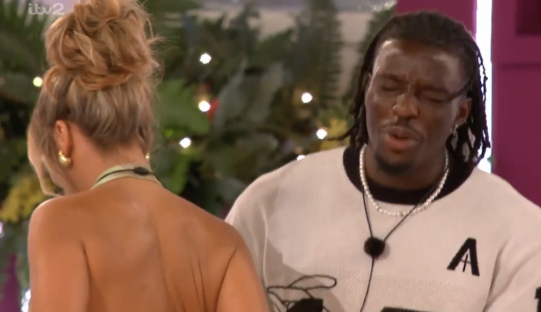 Screenshot of a man and woman speaking.