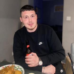 Johnathan Newbury holding a beer.
