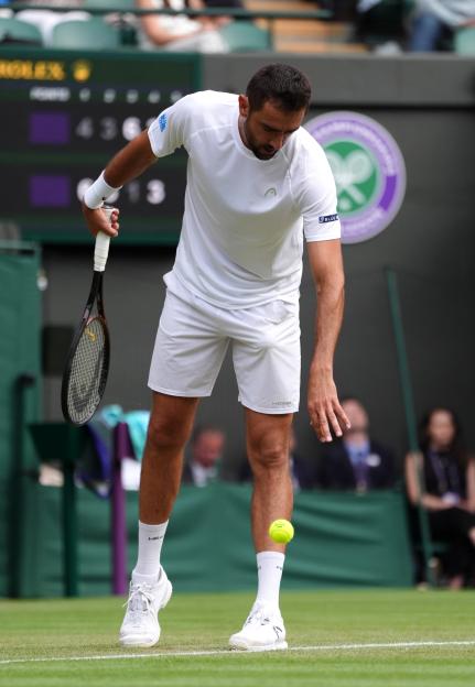 Marin Cilic playing tennis at Wimbledon.