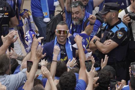 Real Oviedo players celebrating with fans.