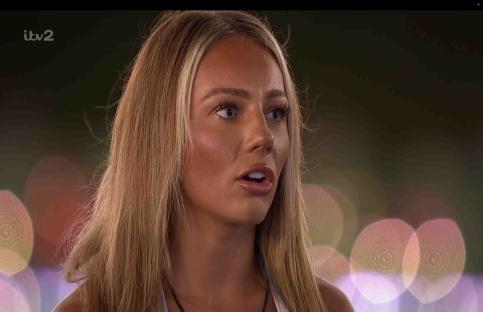 Meg from Love Island watching the boys on a giant screen.