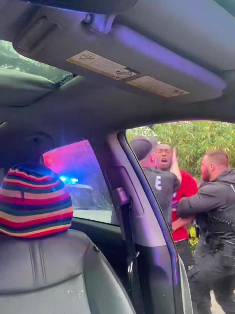Police officers arresting a man.