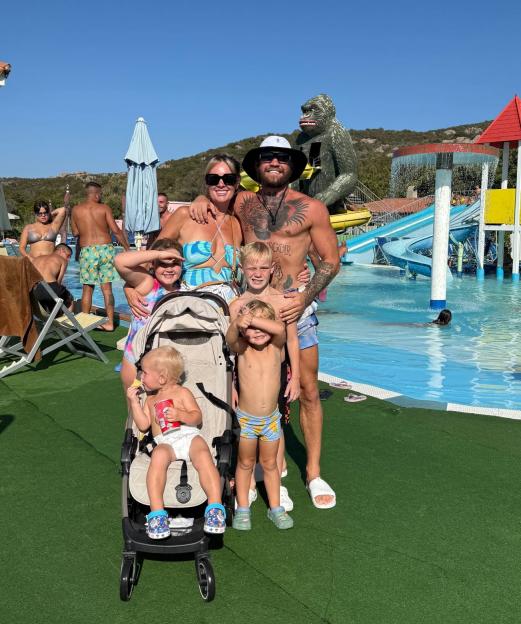 Family posing at a water park.