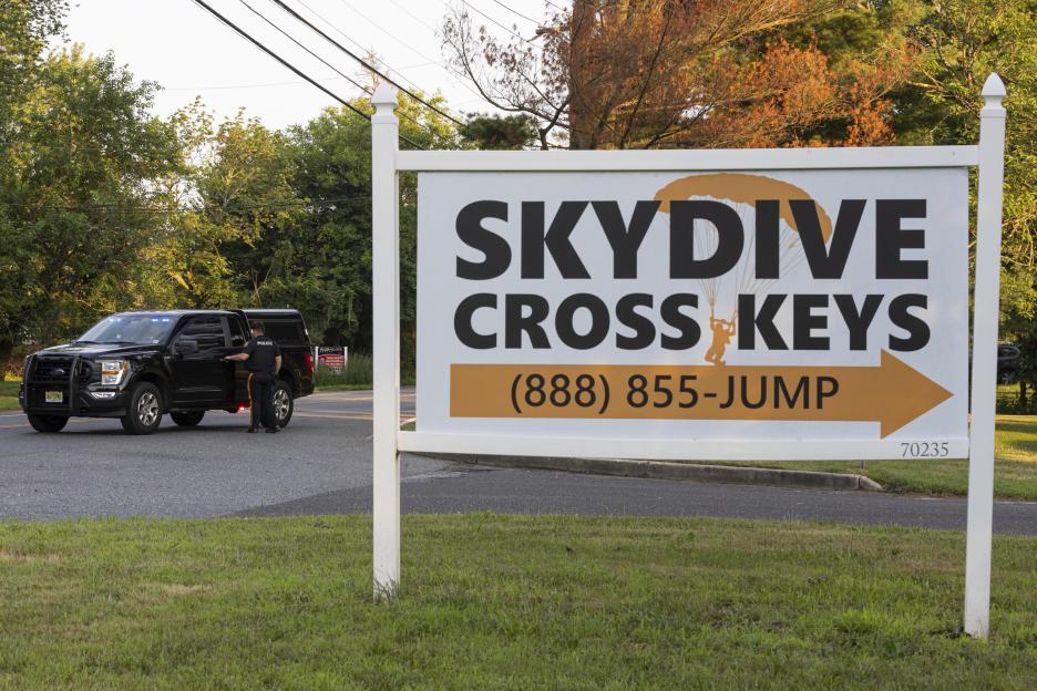 Skydive Cross Keys sign near a New Jersey State Police vehicle.