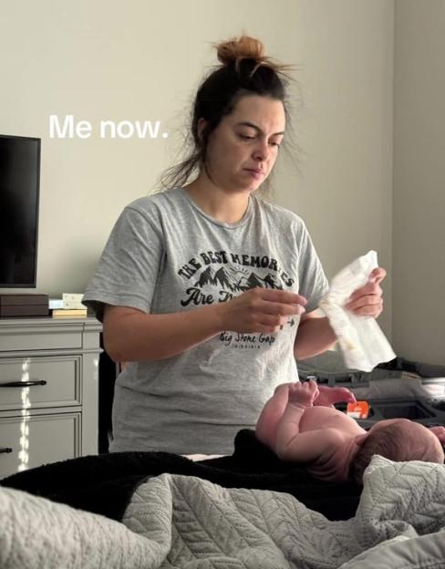 A mother changing her baby's diaper.
