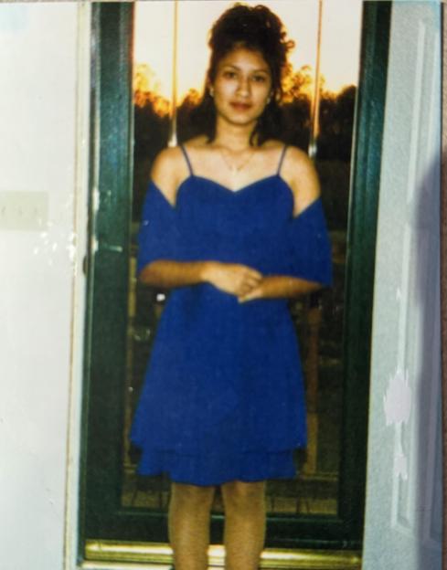 Photo of a young woman in a blue dress.