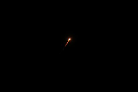 Interceptor missile in the night sky.
