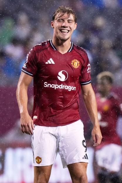 Rasmus Højlund, Manchester United forward, smiling during a soccer game.