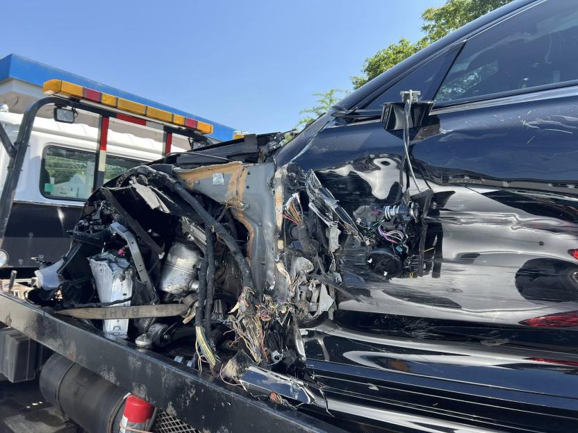 Severely damaged car on a tow truck.