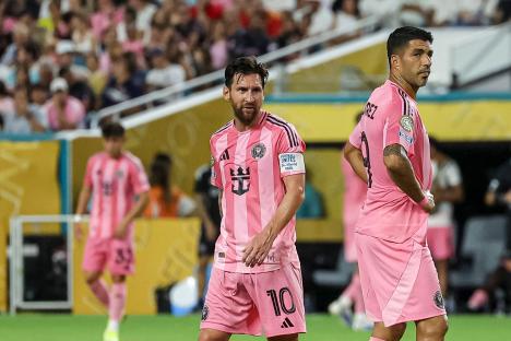 Lionel Messi and Luis Suarez in pink Inter Miami CF uniforms.