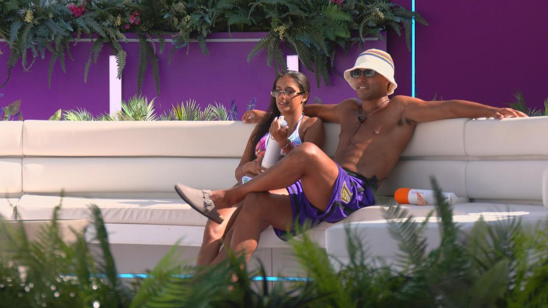 Shakira and Conor sitting on a white couch.