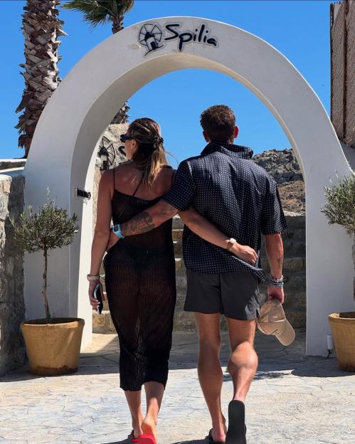 Couple walking away through archway.