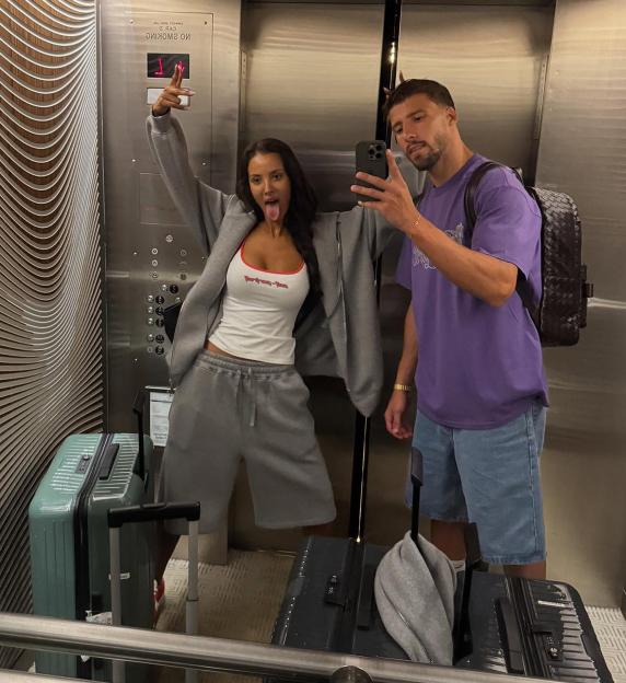 Photo of a couple taking a selfie in an elevator.
