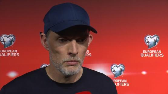 Man in a baseball cap at a European Qualifiers press conference.