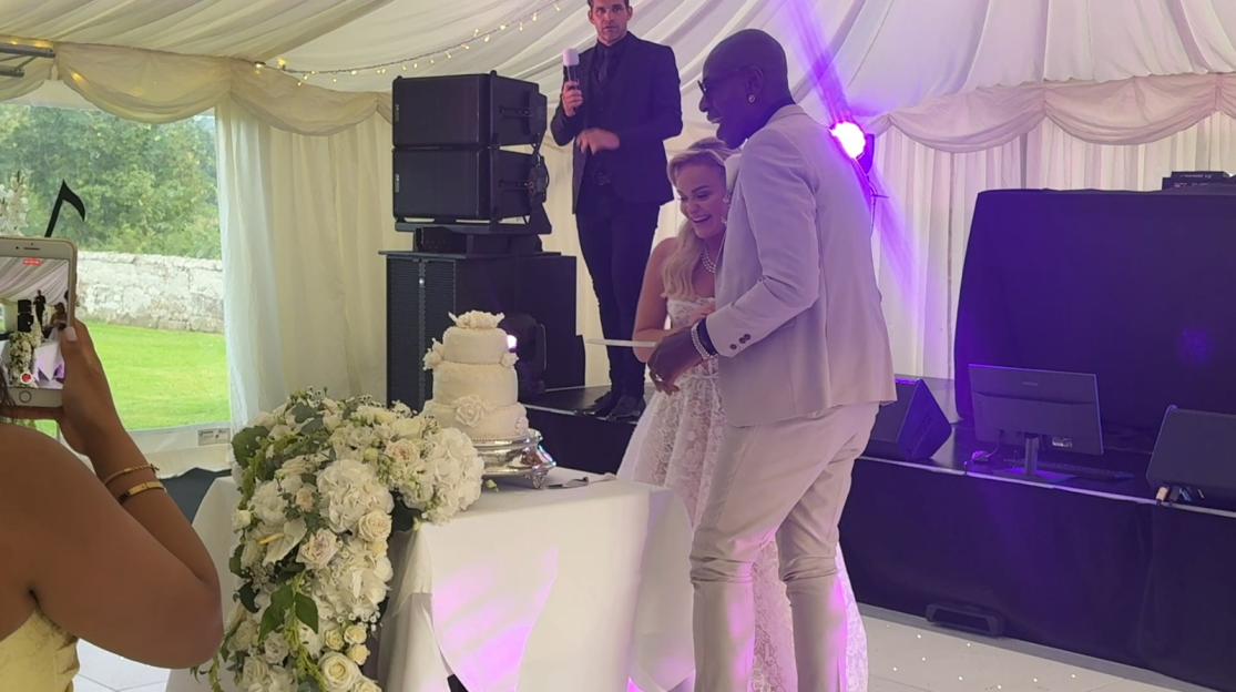 A bride and groom cutting their wedding cake.