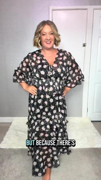 Woman modeling a floral midi dress.