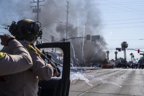 Protesters clashing with law enforcement during a demonstration against immigration raids.