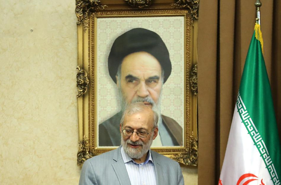 Mohammad-Javad Larijani at a meeting with foreign ambassadors in Tehran, with a portrait of Ayatollah Ruhollah Khomeini in the background.