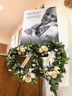 Floral tribute with photo of mother and baby, and names Mellodie and Athena.