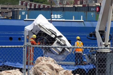Debris from the Titan submersible being unloaded from a ship.