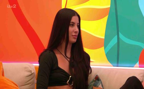 Yasmin from Love Island sitting on a sofa.