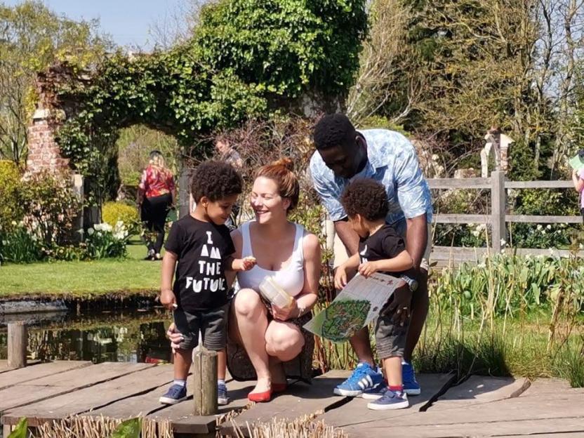 Family with twin boys at a park.