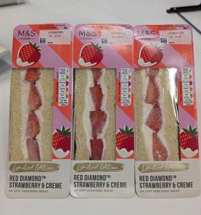 Three M&S Red Diamond Strawberry & Creme sandwiches on soft sweetened bread.